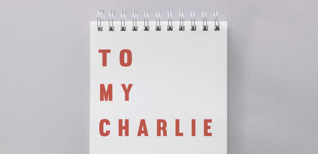 Notebook with the words To My Charlie written on which is the title to my short story.